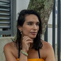 A woman in an orange dress sitting on a bench