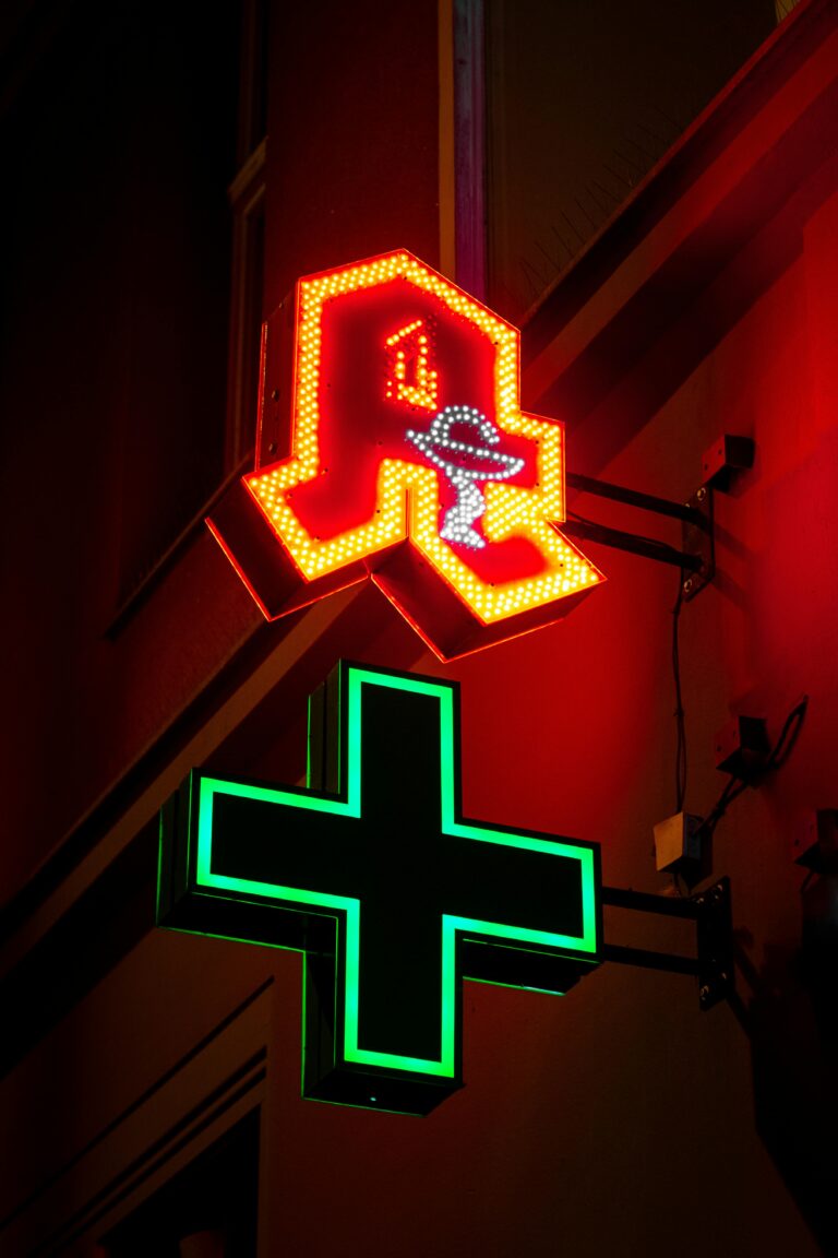 Bright neon pharmacy signs illuminate the night in Berlin, Germany.