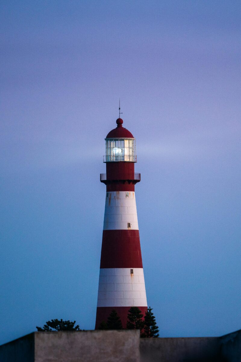 Beautiful lighthouse at dusk in Mar del Plata, Argentina, against a serene sea backdrop.